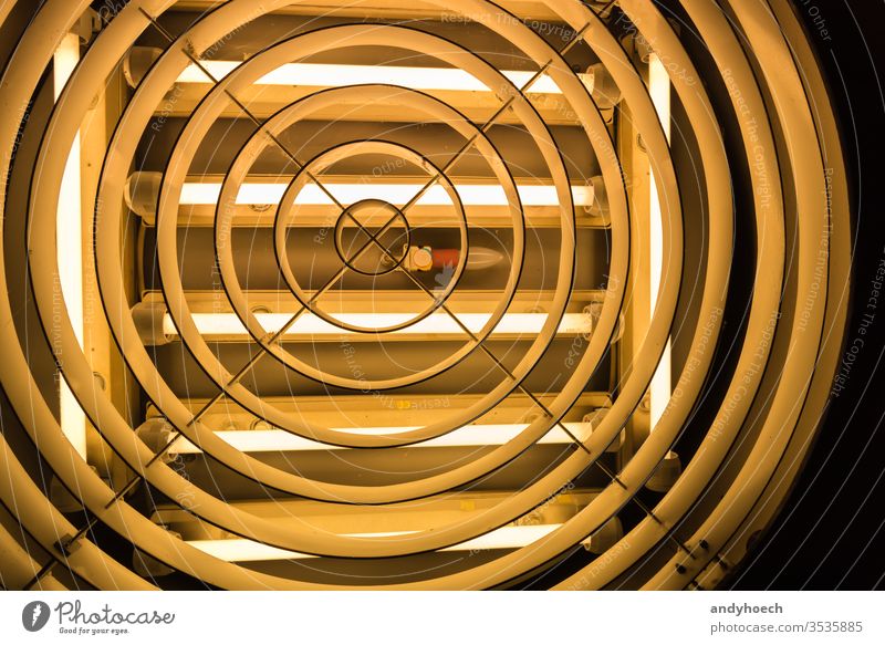 An old light bulb in the middle of fluorescent tubes abstract Art backdrop Background backgrounds built structure ceiling ceiling light circle creative