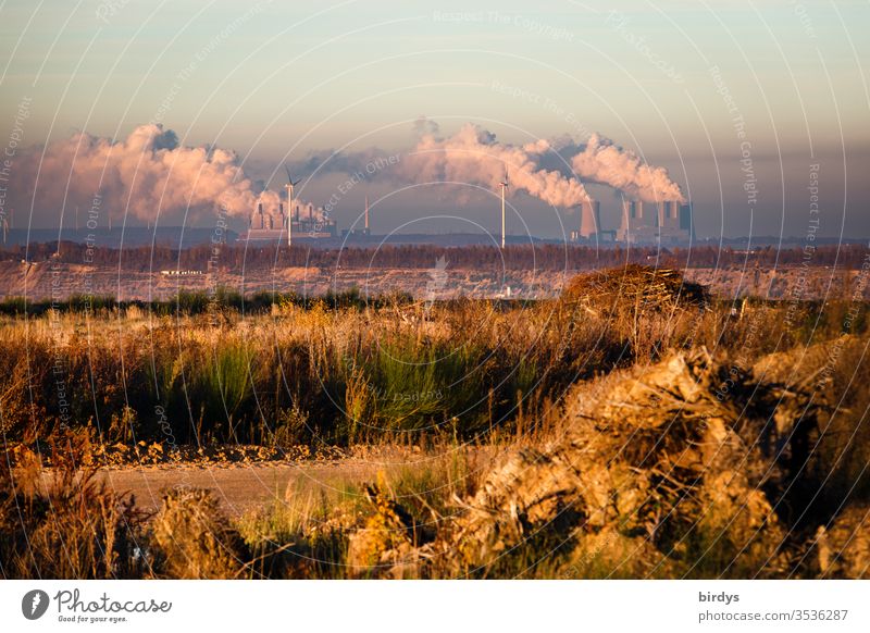 On the edge of the Hambach opencast lignite mine in NRW with a view of smoking lignite power plants Soft coal mining Lignite power plant Coal power station