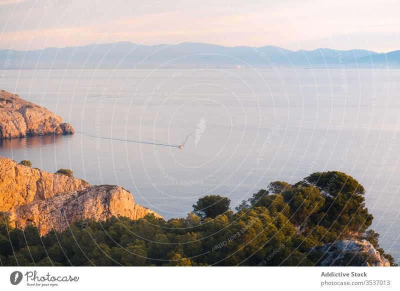 Ship floating on water near coast in sunny day ship boat sailing rock shore sea ocean weather surface cliff wave foam panorama picturesque wonderful view summer