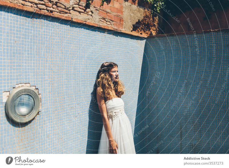 Sensual young bride in stylish white wedding dress standing in empty pool woman elegant sensual romantic blond summer alone shabby style beautiful beauty slim