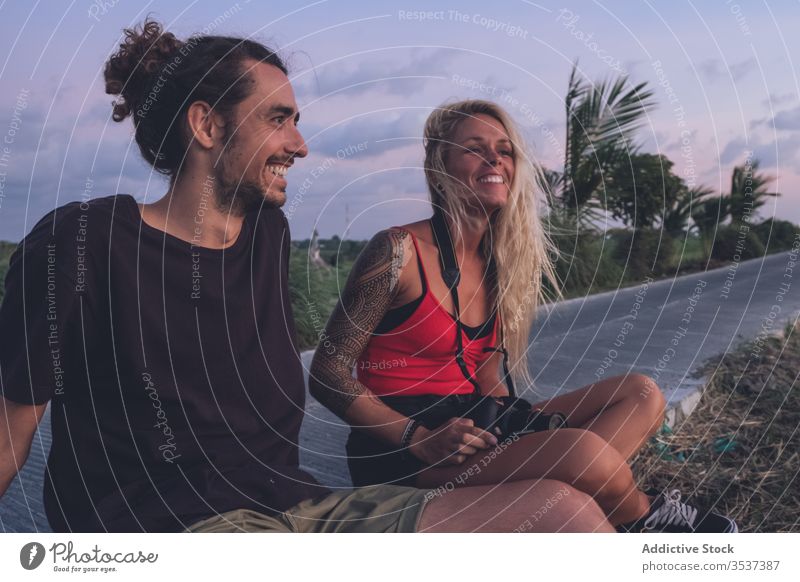 Delighted couple enjoying sunset during vacation evening traveler hipster roadside tropical sundown delight freedom inspiration content cheerful smile positive