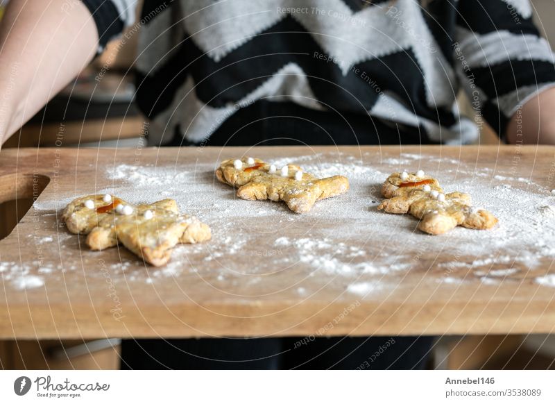 woman's hands holding baking tray with homemade gingerbread man biscuits in the kitchen Cookie Self-made Public Holiday Christmas Gingerbread Woman Food Festive