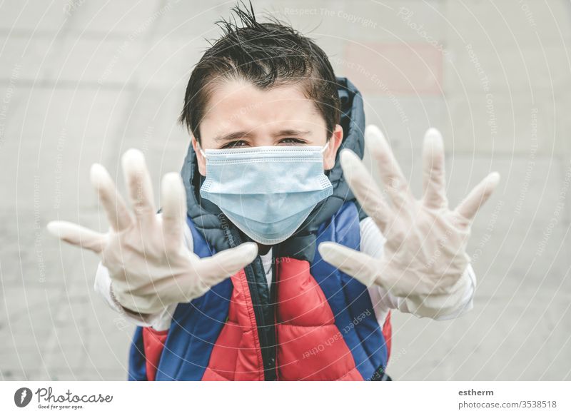 close-up of kid wearing medical mask spreading hands up coronavirus child epidemic pandemic quarantine covid-19 symptom medicine health childhood protection