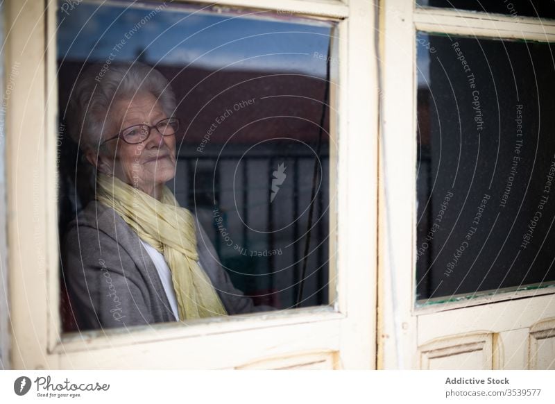 Senior woman looking out window senior coronavirus home lonely anxious desperate unhappy sad quarantine prevent old female protect alone depression stress tired