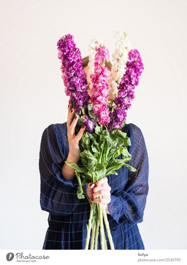 Creative female faceless portrait with bunch of flowers pink mothers day woman spring matthiola incana purple romantic bouquet womens day gift trendy dark dress