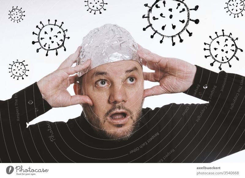 paranoid man wearing tin foil hat against corona virus covid-19 conspiracy theory coronavirus paranoia fear pandemic sars-cov-2 comic 5G aluminum tinfoil