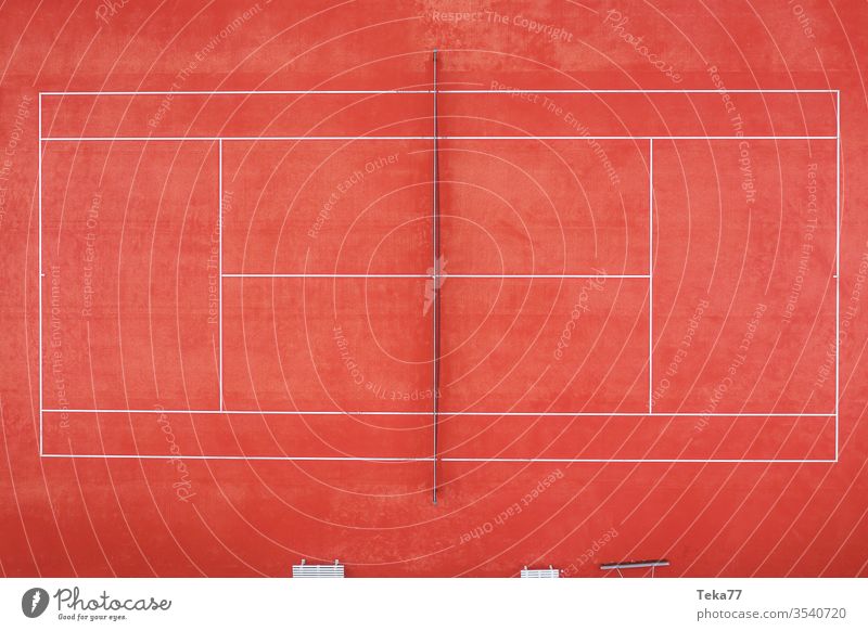 an empty tennis court from above sport sports tennis courts ash orange white lines sun shadow summer winter sharp tennis net tennis nets ball balls tennis ball