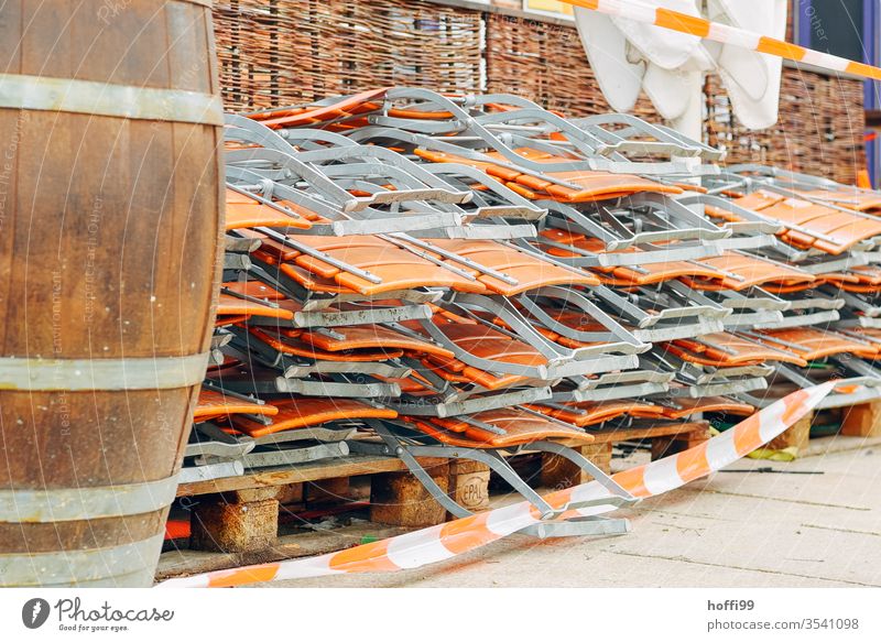 stacked folding chairs on an outdoor terrace covid-19 lockdown curfew restriction Beer tent set Autumn beer garden season beer garden set Beer garden