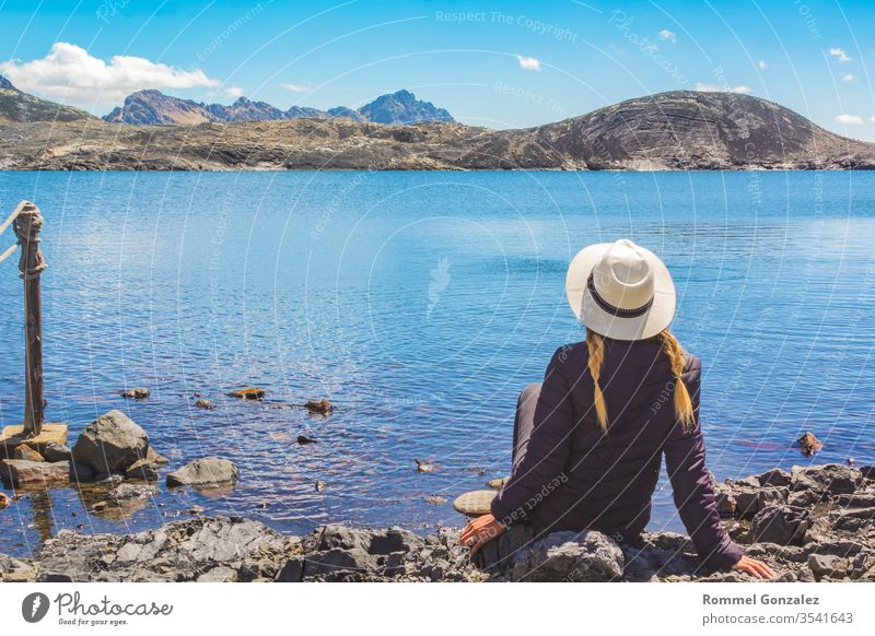 Beautiful woman enjoying landscapes the lagoon of Llanganuco, Huraz. Peru. relax outdoor scenics destination leisure vacations happiness people traveling