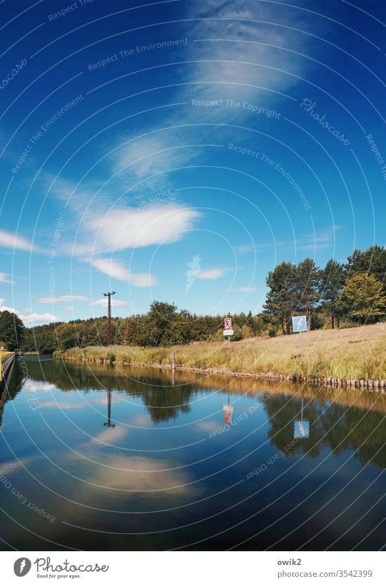 stream Channel Waterway Sky cirrostratus cloud Pole sign Caution lightning bolt electricity Colour photo Exterior shot Deserted Blue Electricity pylon