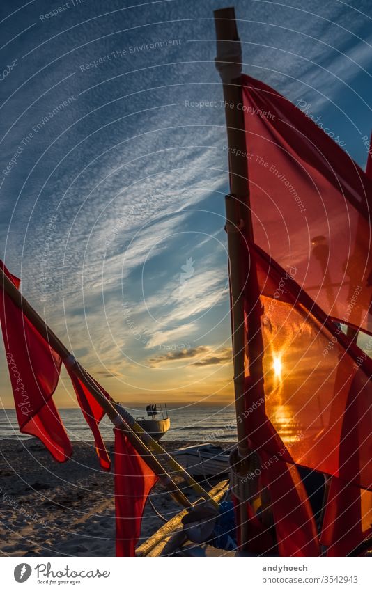 The flags of the fishing boat in front of the sunlight baabe baltic sea beach beautiful beauty cloud clouds coastline craft early fishnet freedom heaven horizon