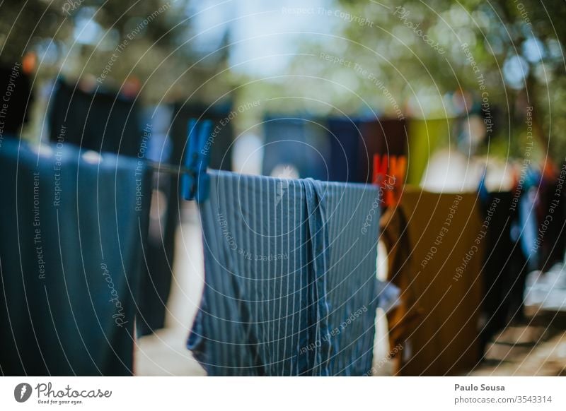 Clothes on a clothesline to dry Clothing Clothesline Clothespin drying Rope Washing Holder Washing day Exterior shot Clean Hang Dry Multicoloured