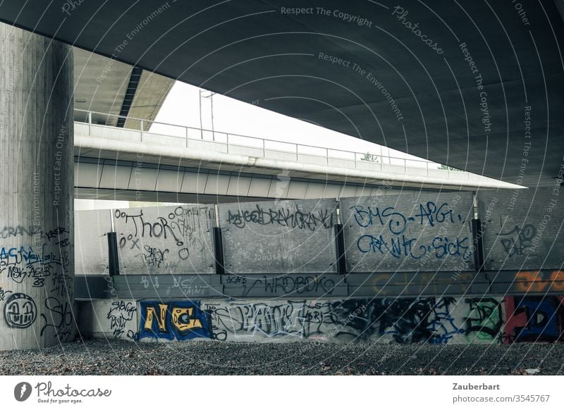 Crossing motorways with concrete pillars, bridges, privacy screens and graffiti Highway piers Concrete Gray cross drive Elegant symmetric Technical Transport