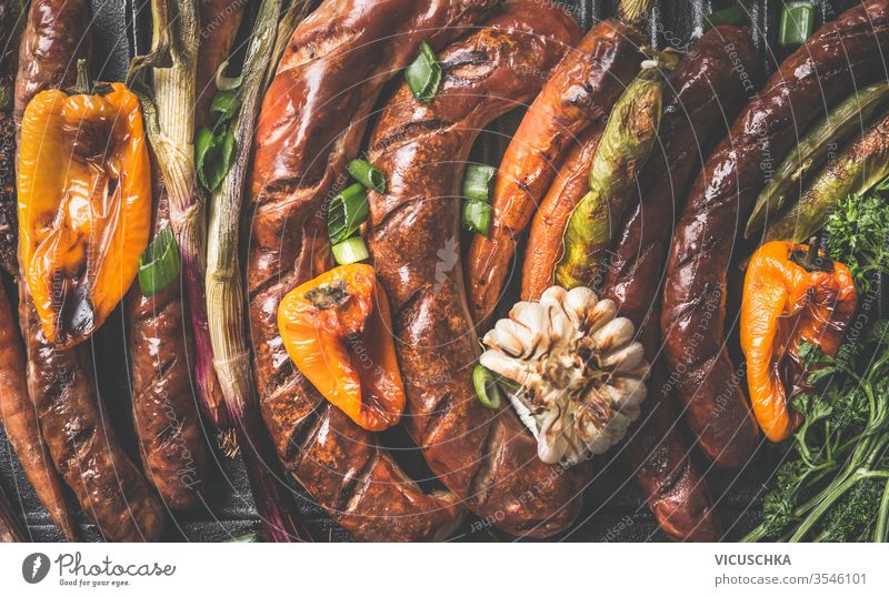 Close up of tasty grilled sausages and  roasted vegetables. Top view. Grill party plate close up top view barbecue above background bbq beef bratwurst close-up