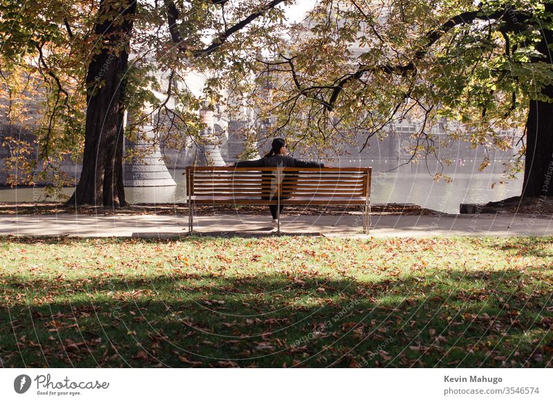 Woman with river in front of her while sitting on a park bench album apartment back contemplation curtain discovery door elegant enjoyment ethnic exploration