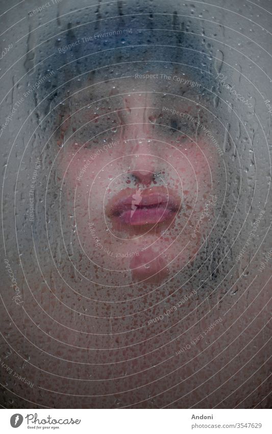 Girl kissing throught bath glass Portrait photograph Shallow depth of field Colour photo Interior shot Copy Space bottom Foam bath Bathtub Personal hygiene