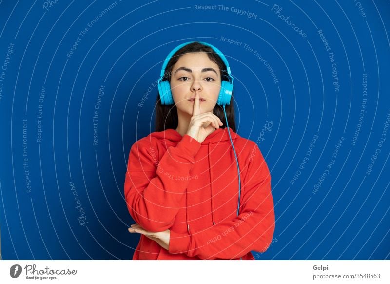 Brunette young girl wearing red jersey person blue music enjoy dj headphones listen earphones technology modern relaxed silence believe portrait expression