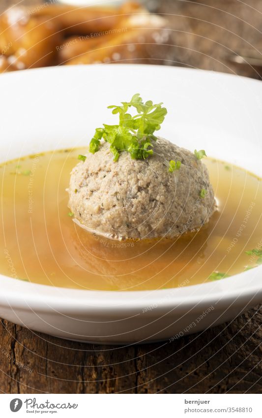 Bavarian liver dumpling soup on wood Meal farce Onion Home Style Parsley greasily Fat carrots Austria ingredient liver dumplings Close-up Eating Brown Liver