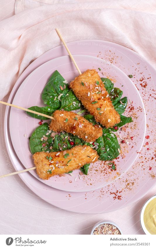 Battered chicken skewers in fried panko on restaurant table breaded food crispy snack meal golden appetizer dinner crunchy gourmet coated delicious cooked hot