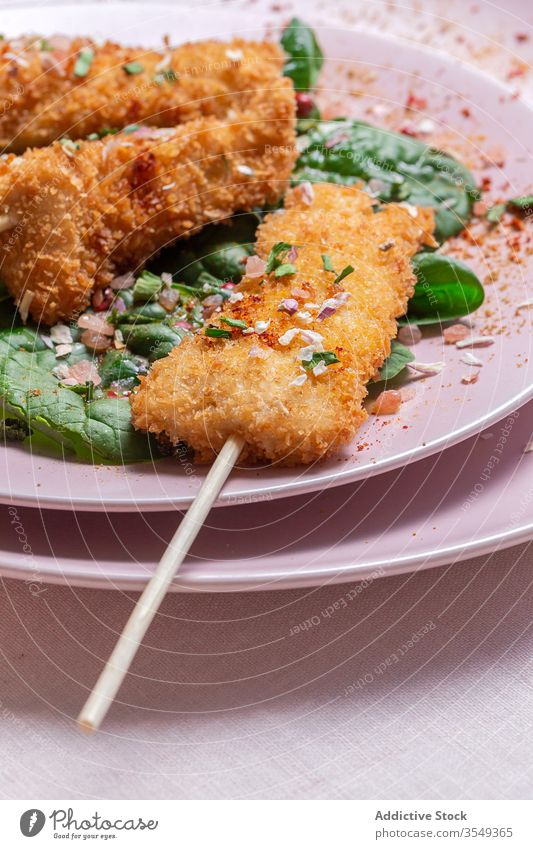 Battered chicken skewers in fried panko on restaurant table breaded food crispy snack meal golden appetizer dinner crunchy gourmet coated delicious cooked hot