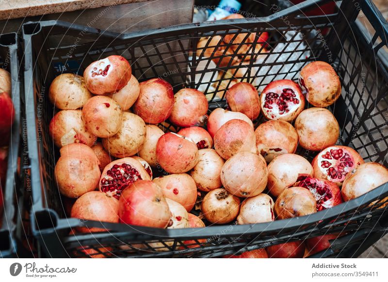 Basket with fresh pomegranates on market ripe red sweet cart basket shop fruit summer sunny day food delicious organic store vitamin healthy attractive commerce