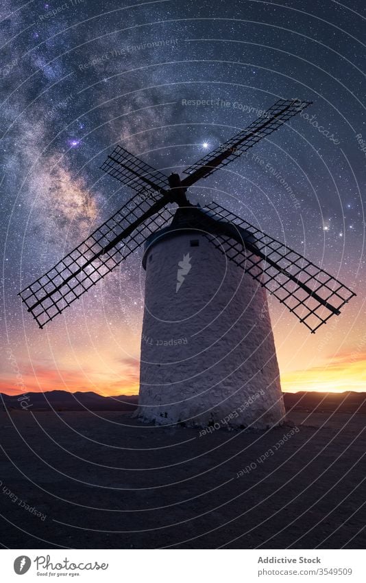 Rocky hill with dutch windmill at starry night landscape milky way mountain rock sky spectacular dark scenery magnificent evening amazing scenic galaxy universe