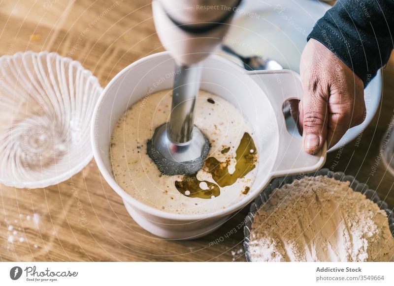 Woman mixing ingredients for pastry mixer housewife bake homemade dough kitchen prepare cook woman recipe food oil flour milk bowl sweet muffin dessert process