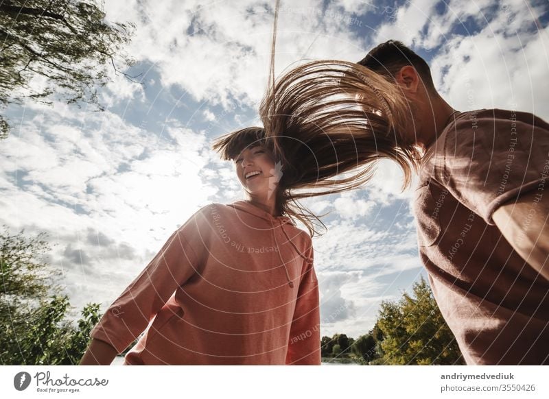 crazy young couple emotionally having fun, kissing and hugging outdoors. Love and tenderness, romance, family, emotions, fun. having fun together beach happy