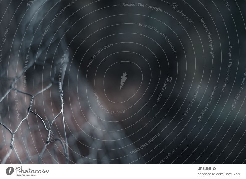 bent wire mesh fence with dark background Fence Wire netting Wire netting fence conceit somber Threat warped Deserted Exterior shot Barrier Fenced in fenced