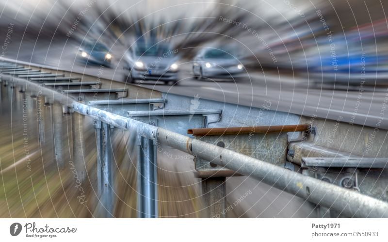 Guardrail at the motorway with cars in the background distorted by zoom effect Highway Crash barrier Zoom effect peril Street Transport Car Vacation & Travel