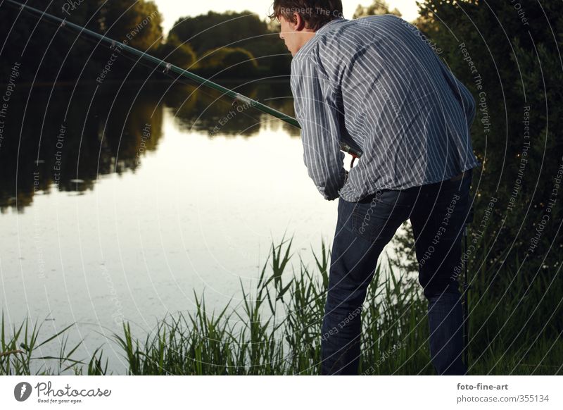 Young man fishing Joy Leisure and hobbies Fishing (Angle) Summer Summer vacation Masculine 1 Human being 18 - 30 years Youth (Young adults) Adults Shirt Jeans