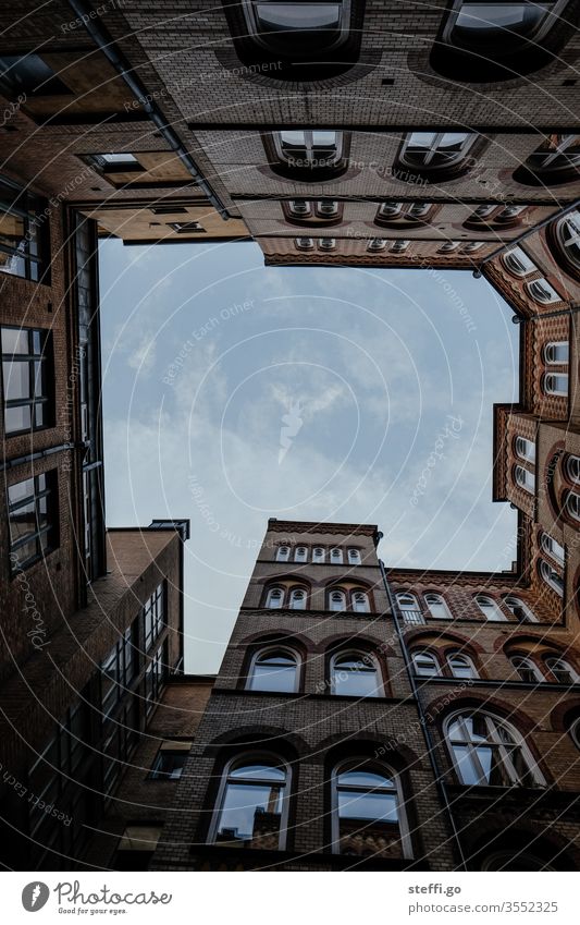 View upwards in an inner courtyard; sky surrounded by buildings; frog's eye view Backyard built Worm's-eye view Sky Architecture Perspective