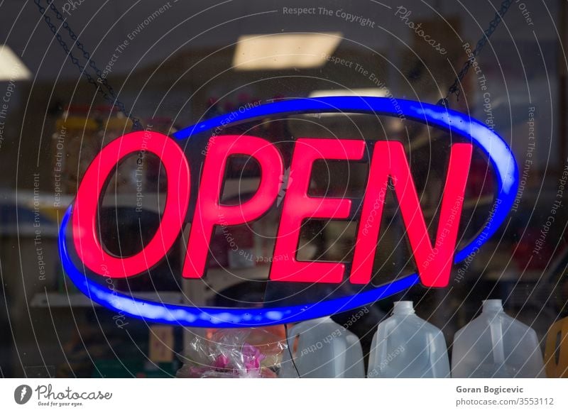 Open sign red neon shop light open symbol night dark retail shopfront window evening restaurant bright entrance illuminated design electric circle signboard