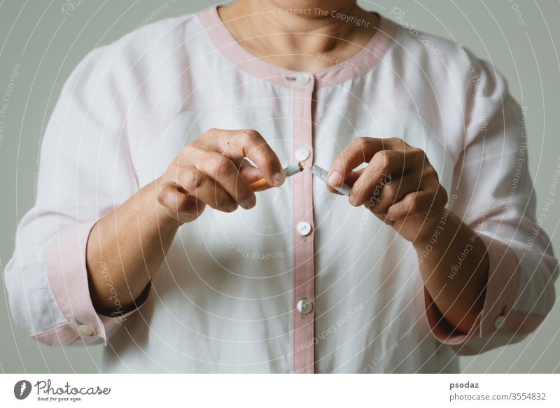 Quit smoking, no tobacco day, mother hands breaking the cigarette addict adult aged anti background bad beautiful broken care caucasian close up concept danger