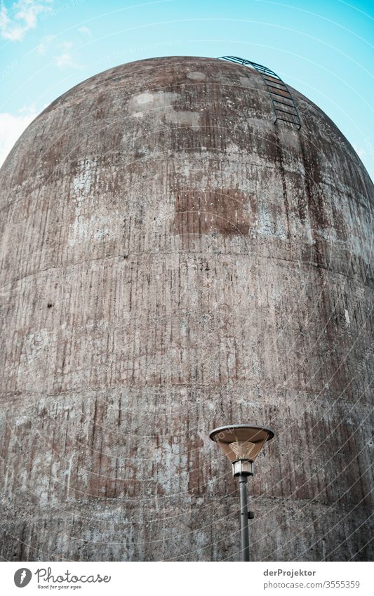 Lantern in front of the concrete wall of a spinning tower structure Experimental Light Day Copy Space middle Copy Space top Exterior shot Colour photo Berlin