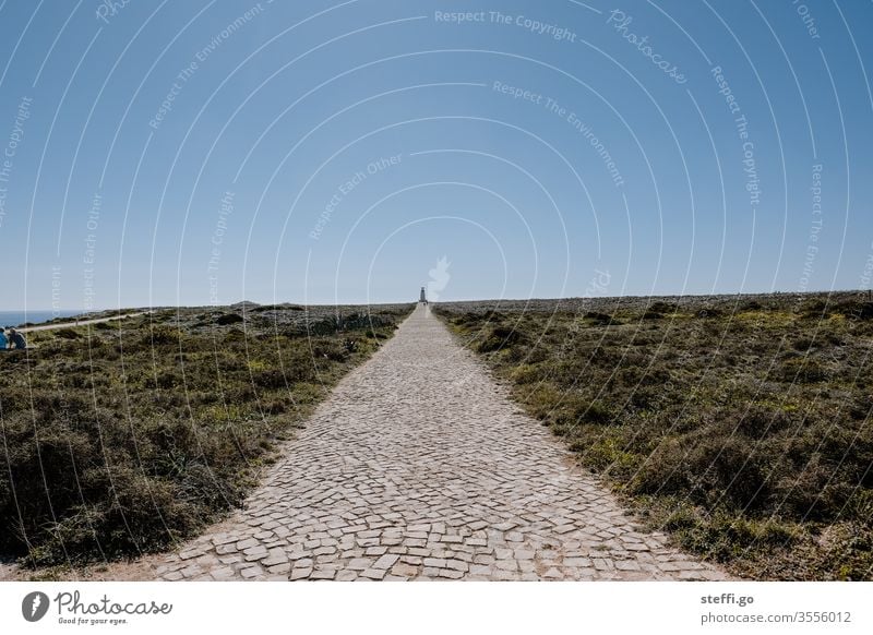 paved path to a tower on the horizon Horizon wide Lanes & trails Portugal Sagres Algarve Ocean Colour photo Coast Vacation & Travel Exterior shot