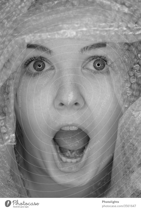 Young woman surprised or startled? Scream 18 - 30 years Interior shot Fear Panic peer big eyes Teeth Mouth Mouth open Face portrait Nose Lips Human being Eyes