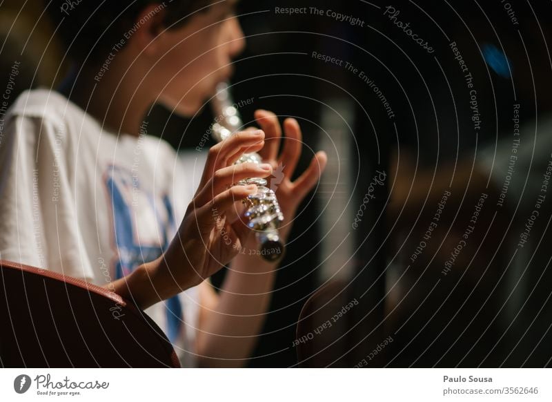 Kid playing flute Flute Flute-player Music Colour photo Human being Musician Interior shot Day Musical instrument Close-up Detail Musical instrument string