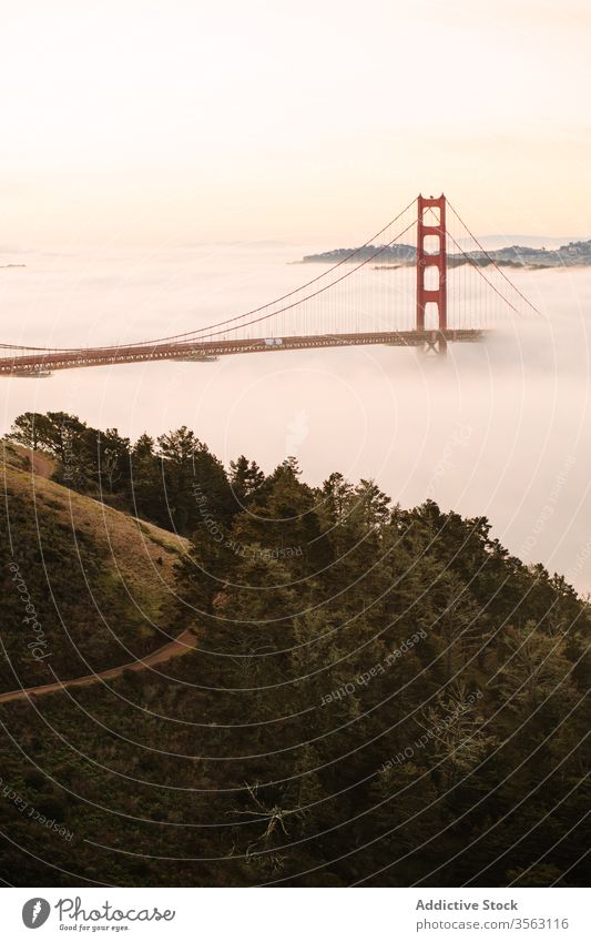 Famous Golden Gate Bridge on foggy evening bridge golden gate sightseeing sunset famous way strait construction architecture landscape sundown destination warm