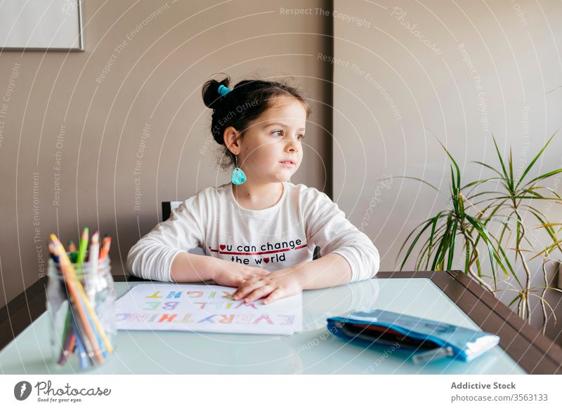 Concentrated little girl drawing with pencil at home table picture kid concentrate develop preschool paint inspiration hobby child creative wooden focus art