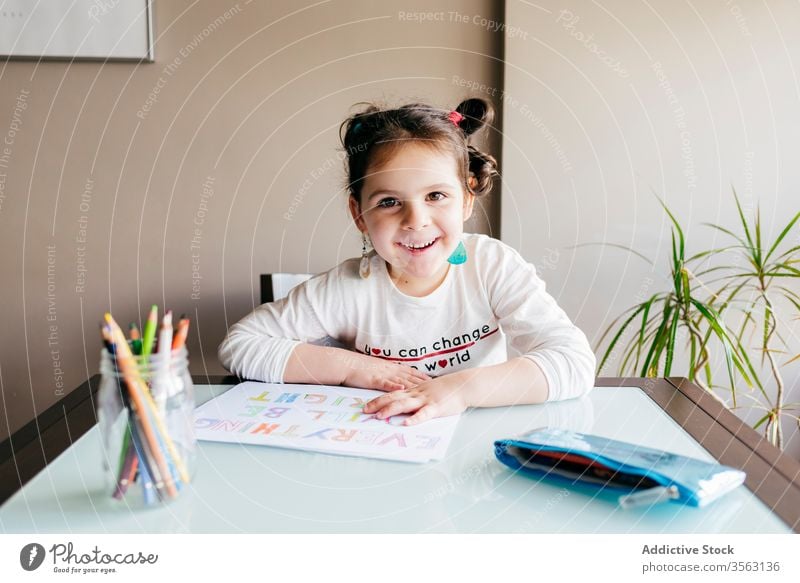 Concentrated little girl drawing with pencil at home table picture kid concentrate develop preschool paint inspiration hobby child creative wooden focus art