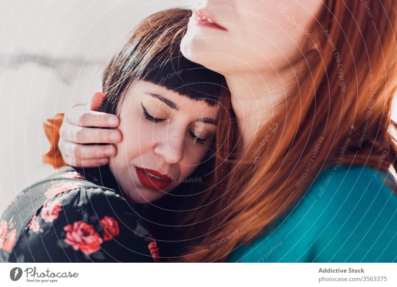 Sensual girlfriends embracing in snowy park women sensual model winter style relationship embrace lesbian tender love affection nature hug romantic close