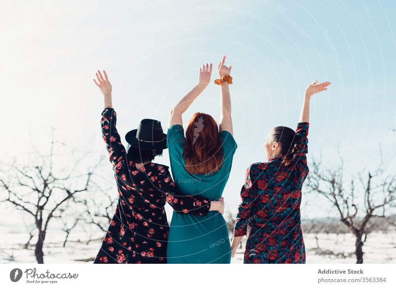 Happy fashionable women standing on snow together happy fun winter field friend cheerful trendy nature style female young joy smile relax relationship laugh