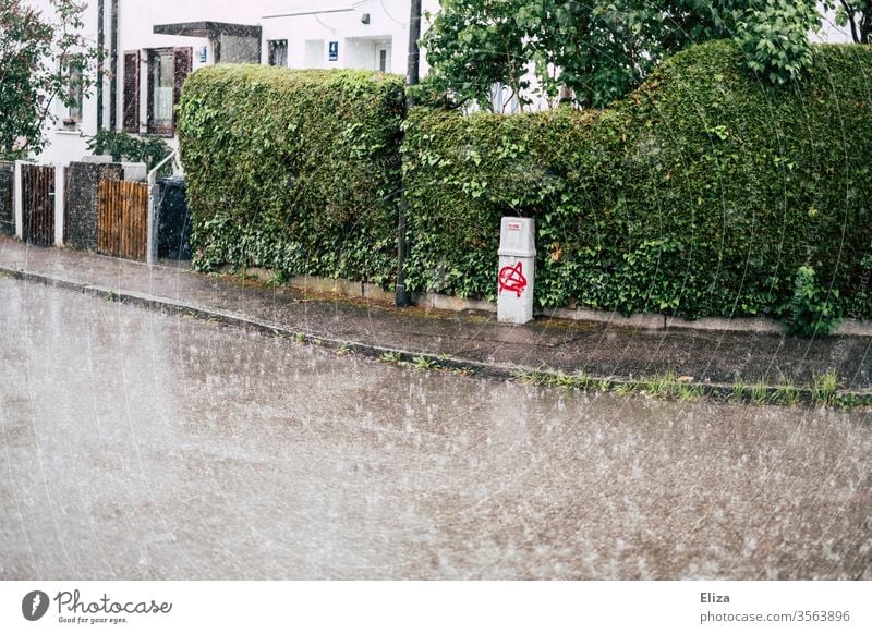 A street in a residential area in heavy rain Rain downpour Empty Street Wet Bad weather Weather Autumn Residential area Sidewalk Strong Gloomy Gray green