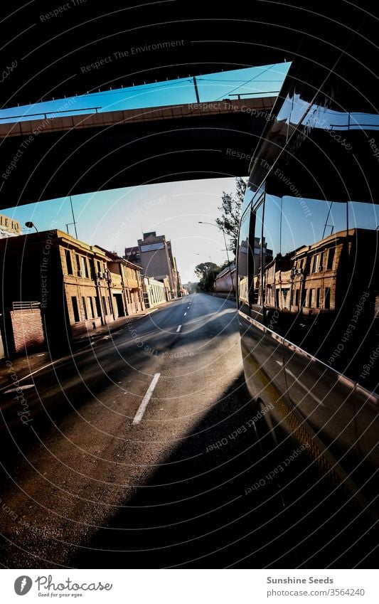 Looking back street view in a quiet city from a mini bus taxi window vehicle shadow 3rd world metro empty tourism trip adventure africa south johannesburg