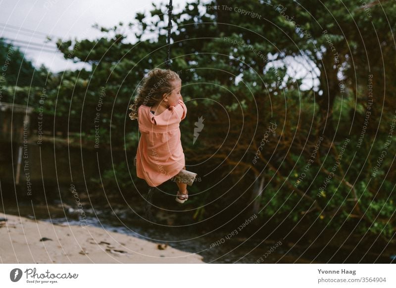 Swinging in Hawaii Hibiscus To swing Rocking Joy Playing Exterior shot Colour photo Playground Infancy Day Child Children's game Copy Space right Movement