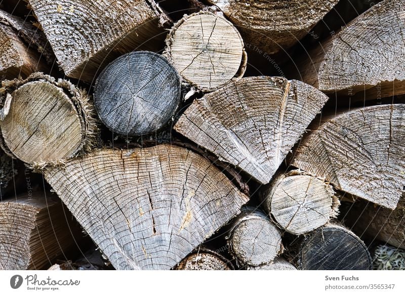 Logs stacked on top of each other along a forest path logs Firewood regenerative energy Renewable energy Natural product resource Round Stacked up round wood