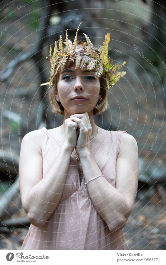 A young beautiful boho girl in a a forest background spirit glamour ethnic pretty free standing lady trees romantic wood posing woman person tribal breathe calm