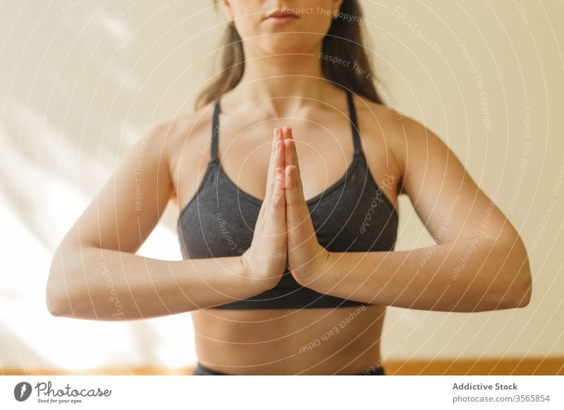 Tranquil woman meditating in Lotus pose lotus pose meditate yoga namaste padmasana mindfulness tranquil focus home female concentrate exercise mat training