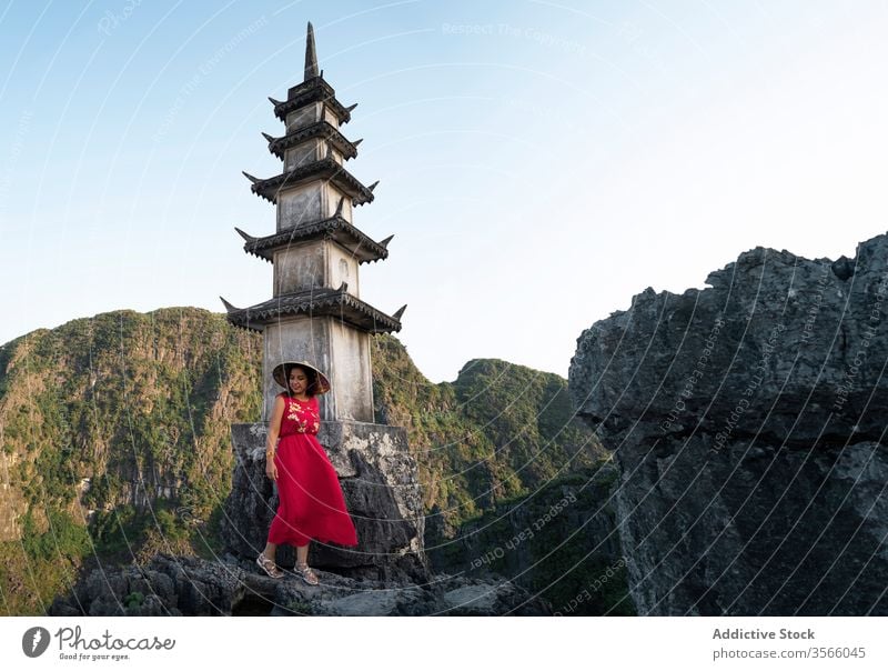 Female tourist near pagoda in Hang Mua hang mua woman travel buddhism tower landmark mountain landscape female mua cave vietnam asia top admire stand scenery